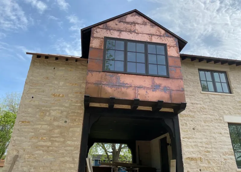 Copper metal panel facade on a stone building for Roof Repair in Lauderhill