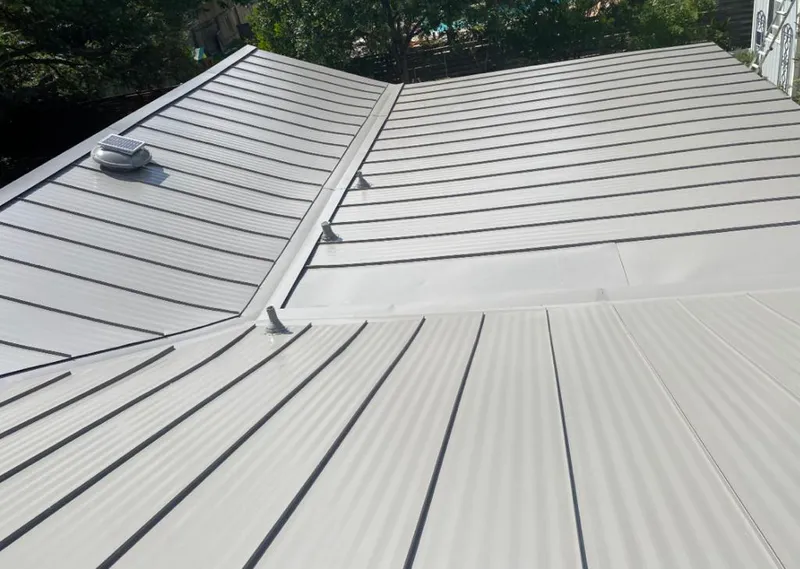 Solar attic fan installed on a metal roof for Roof Ventilation in Lauderhill